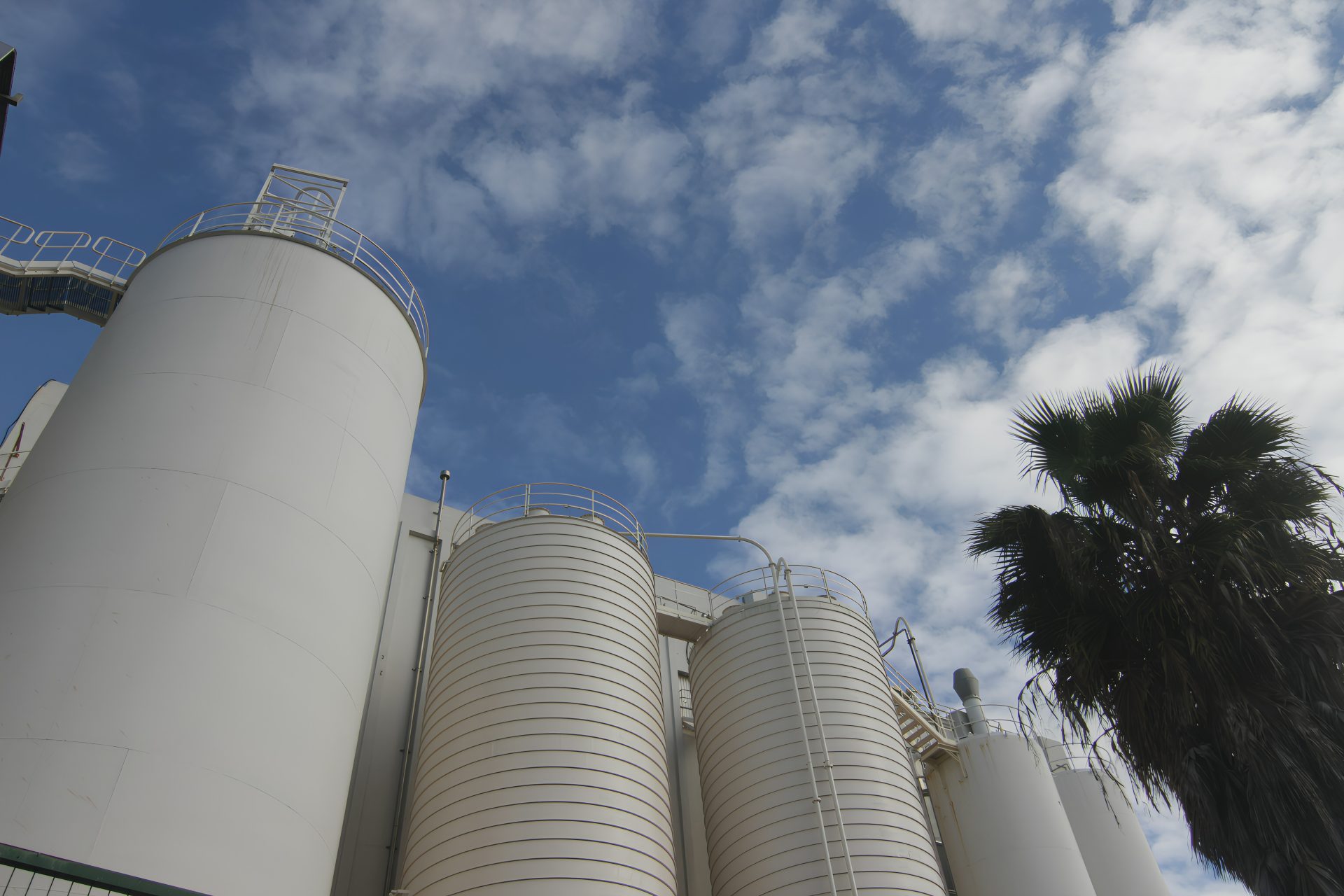 White industrial silos against a blue sky